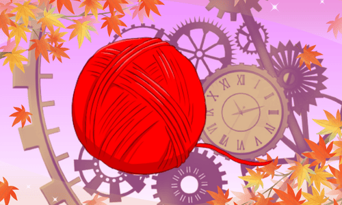 紅葉を背景とした赤い毛糸玉