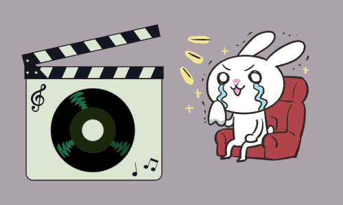 映画撮影のカチンコ(緑色)と映画館の座席で泣いているウサギ